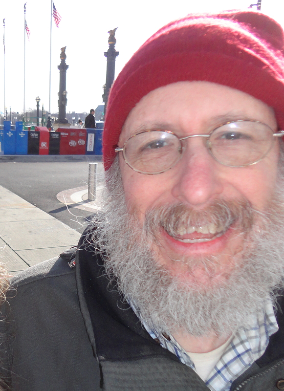 Man with white beard and red hat