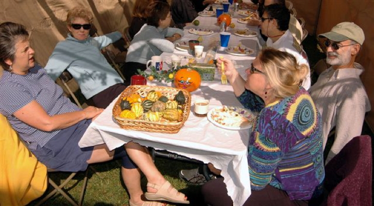Fabrangeners gather to eat together in the community sukkah.
